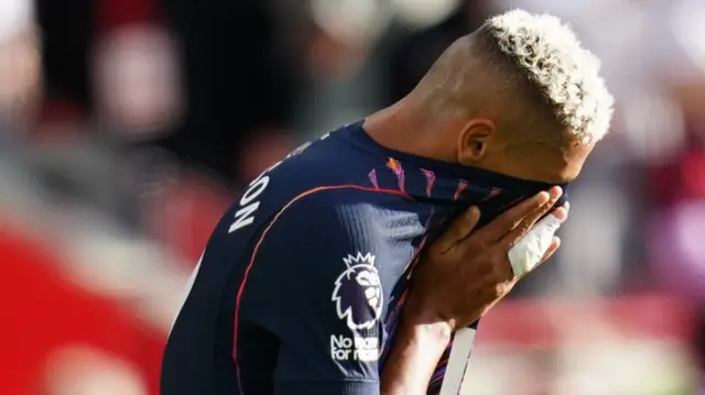 Richarlison holds his shirt over his face