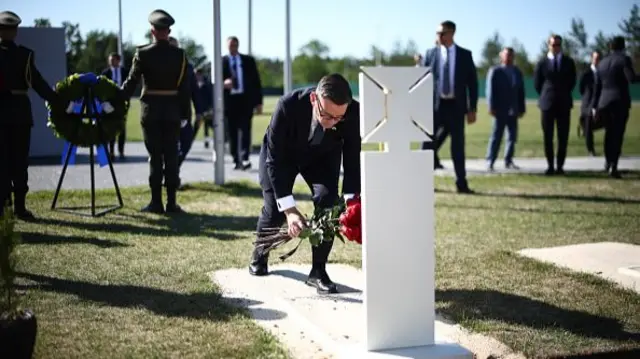 Burnham lays some flowers at the grave of the unknown soldier during a visit to Ukraine