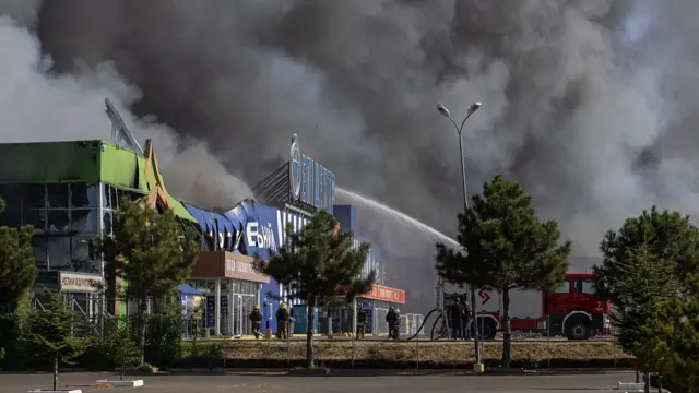 Ukrainian firefighters work at the site of a shopping centre that was hit during a Russian air attack in Odesa on August 24, 2026.