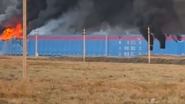 A screengrab from the video showing a large building on fire