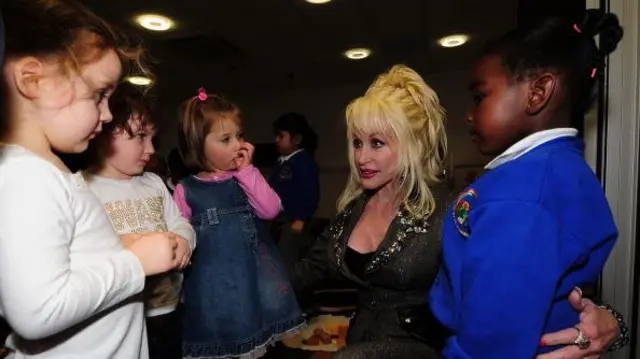 Parton stands with four young children