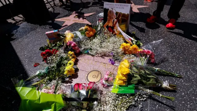 People leave flowers and memorabilia at the Hollywood Walk of Fame star of singer and actress Dolly Parton following her death
