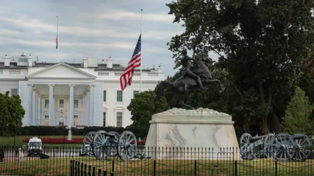 A U.S. flag flies at half-staff in front of the White House in memory of Dolly Parton
