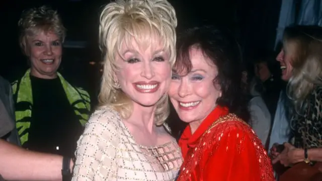 Parton and Lynn together in 1997. They are embracing
