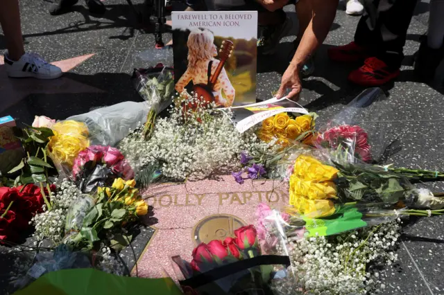 Flowers lie at the star of Dolly Parton on the Hollywood Walk of Fame after it was announced that the country music icon died aged 80, in Los Angeles, California, U.S., August 25, 2026.