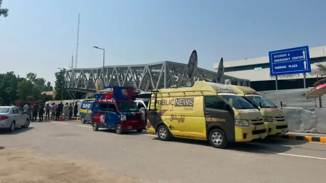 News vans parked outside PIMS hospital in Islamabad Pakistan where a fire killed 14 infants
