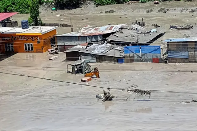 Damaged property and flooded roads following a flash flood in Galchhi in the Dhading district, Nepal, August 26, 2026