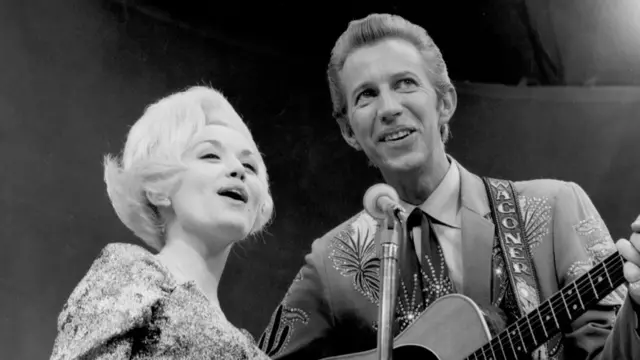 Country singer Dolly Parton and her collaborator Porter Wagoner perform onstage in circa 1967