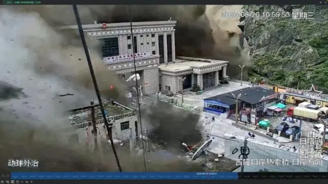 CCTV footage shows people running away as wall of mud and water destroys buildings in a valley in Gyirong, Tibet.