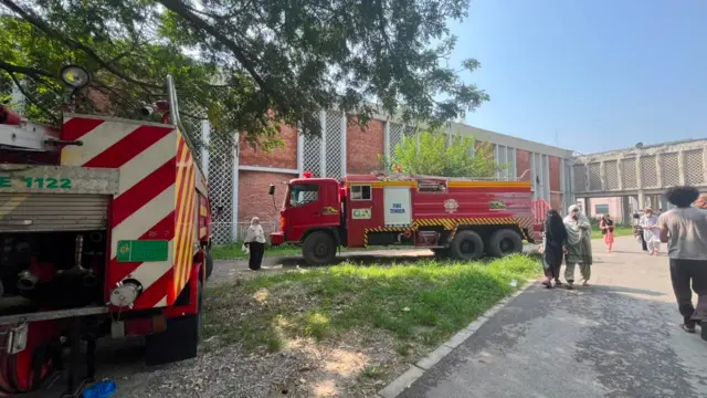 Firetrucks parked outside PIMS hospital in Islamabad Pakistan where a fire killed 14 infants