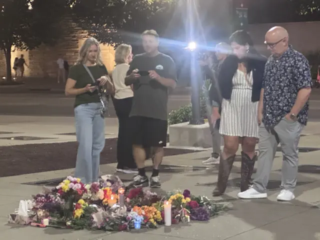 People stood around a tribute to Dolly on the ground