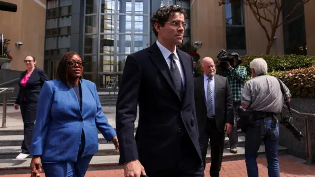 Instagram chief Adam Mosseri leaving the building, with paparazzi behind him