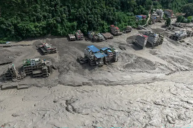 Houses partially submerged along a riverside after flash floods at Trishuli Bazar in Nepal's Nuwakot district