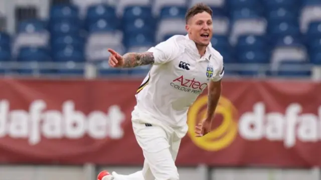 Durham's Brydon Carse celebrates the wicket of Gloucestershire's Joe Phillips (not pictured)