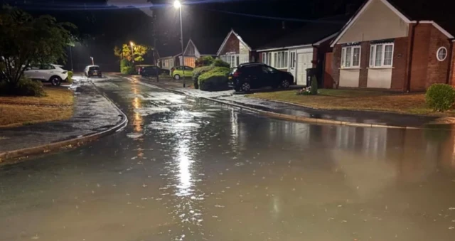 A flooded cul-de-sac at night time