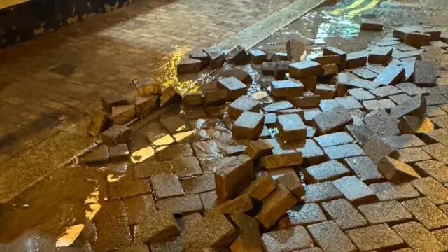 Bricks displaced after water erupted from underneath