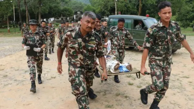 Nepali army officers conducting a helicopter rescue of survivors