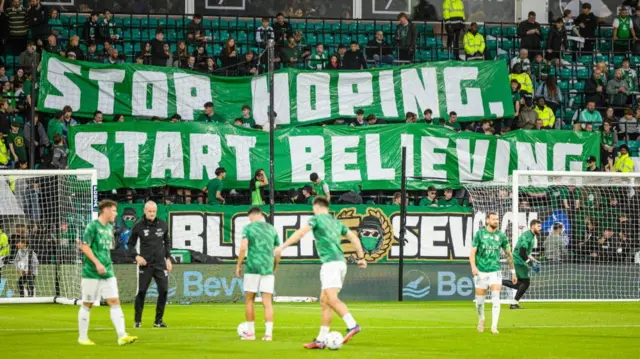 Hibernian players warming up in front of supporters
