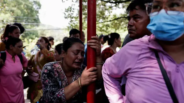 A woman cries as she waits for updates on whereabouts of her missing family member, Nuwakot district, Nepal