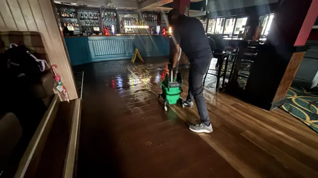 A man cleaning the floor with a specialist machine