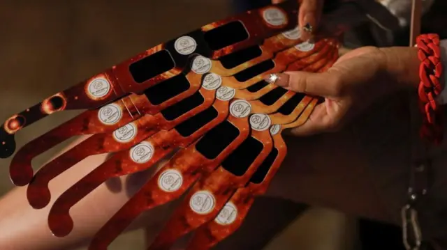 Protective glasses to observe the solar eclipse safely, being handed out ahead of a total solar eclipse in Mazatlan, Mexico, on 6 April 2024