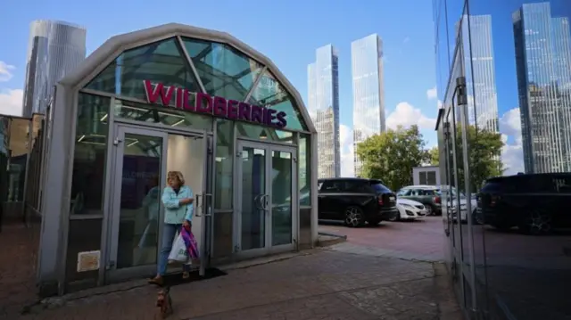 A woman leaving a Wildberries pick-up point