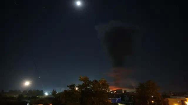 A plume of black smoke rises into the night sky following a reported drone strike by Ukrainian forces in Belgorod, Russia, on August 3, 2026