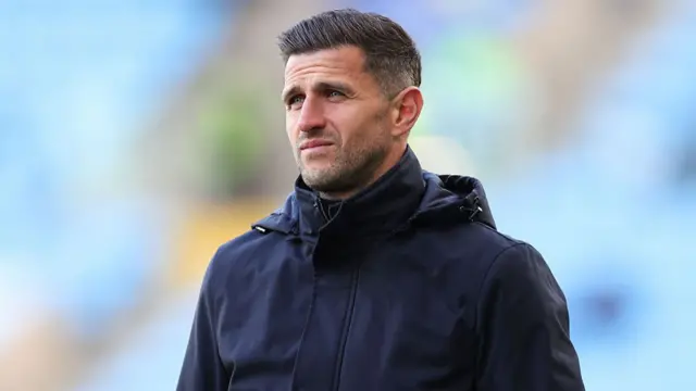 John Mousinho looks on