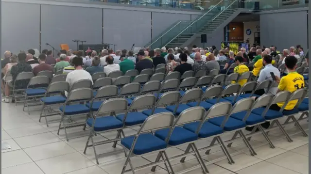 The Forum in Norwich with fans filling up the seats with empty seats in the foreground.