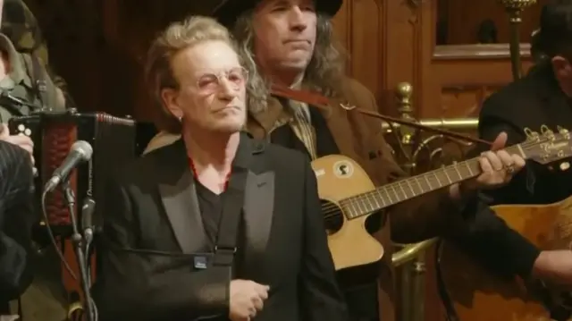 Bono in a crowd of musicians