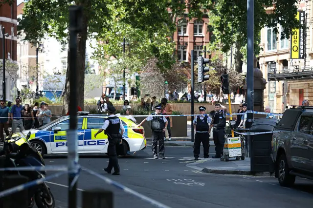 Police Officers stand at a cordon near the Shaftesbury Theatre, pictured from Endell Road in Covent Garden