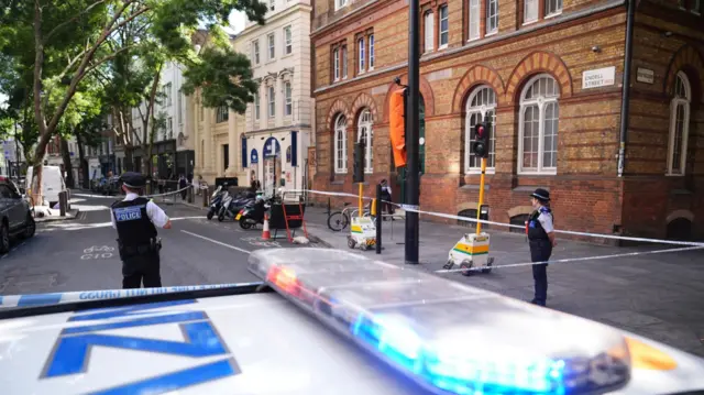 Emergency services near the scene on Endell Street in Covent Garden, central London, after four men were stabbed.