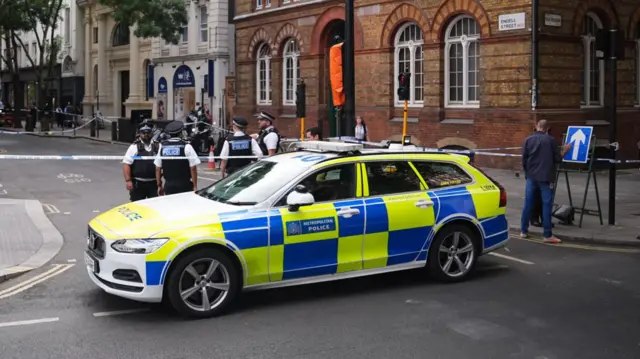 Emergency services near the scene on Endell Street in Covent Garden, central London, after four men were stabbed.