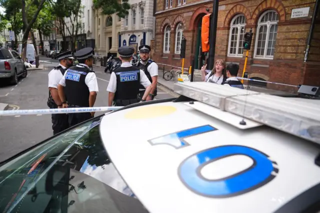 Emergency services near the scene on Endell Street in Covent Garden, central London, after four men were stabbed.