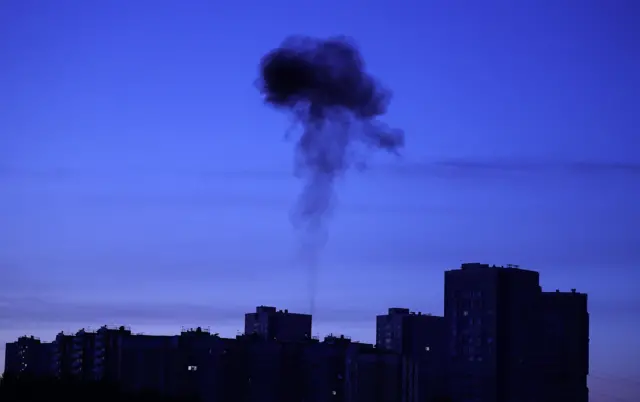Smoke billows from a residential building following a Ukrainian drone attack in Domodedovo, Moscow Region, Russia