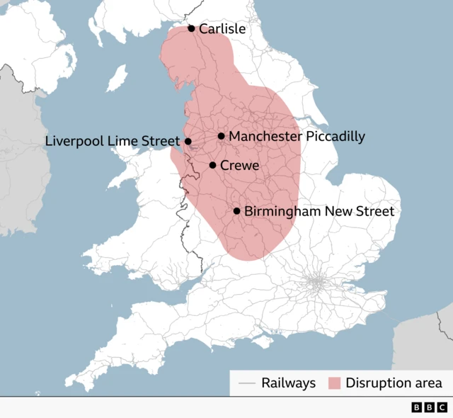 Map of England showing a rail disruption area across much of northern England, highlighted in red. Key stations marked within or near the affected area are Carlisle, Liverpool Lime Street, Manchester Piccadilly, Crewe, and Birmingham New Street. Rail lines are shown in grey