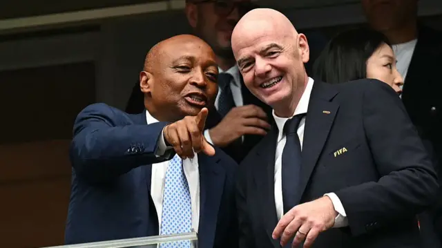 Confederation of African Football (CAF) President Patrice Motsepe (L) points out as he talks with FIFA President Gianni Infantino (R) ahead of the 2026 World Cup round of 16 football match between Canada and Morocco at the Houston Stadium in Houston on July 4, 2026