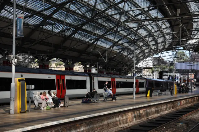 Commuters at Liverpool Lime Street after a power outage in the north west of England