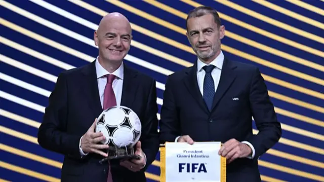 : FIFA President Gianni Infantino and UEFA President Aleksander Ceferin exchange gifts during the 50th UEFA Ordinary Congress at the Brussels Expo