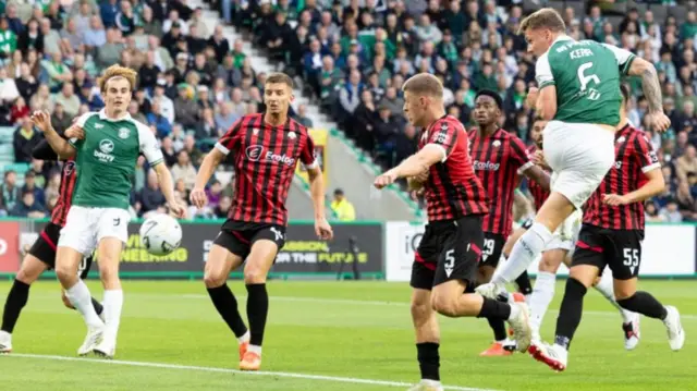 Hibs' Jason Kerr heads for goal