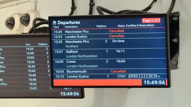 A departure board at Stoke train station showing services to Manchester Piccadilly, London Euston and Bournemouth cancelled