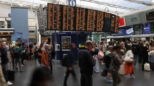 A crowded concourse at Manchester Piccadilly train station