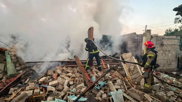 Firefighters work at the site of a private house - heaps of rubble is on the floor