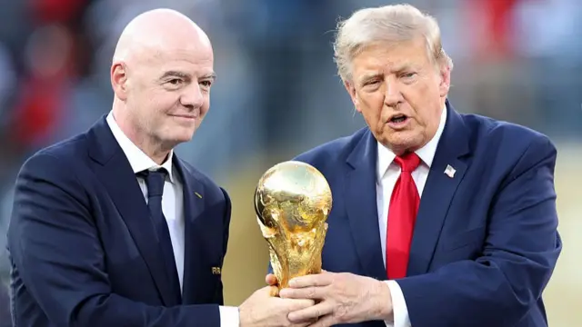 U.S. President Donald Trump and FIFA President Gianni Infantino hold the FIFA World Cup Winner's Trophy before handing over to captain Rodri #16 of Spain