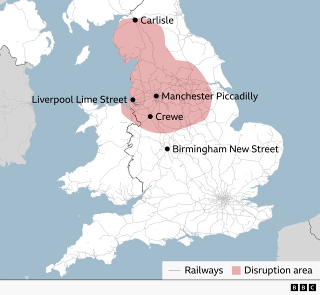 Map of England showing a rail disruption area across much of northern England, highlighted in red. Key stations marked within or near the affected area are Carlisle, Liverpool Lime Street, Manchester Piccadilly and Crewe. Rail lines are shown in grey