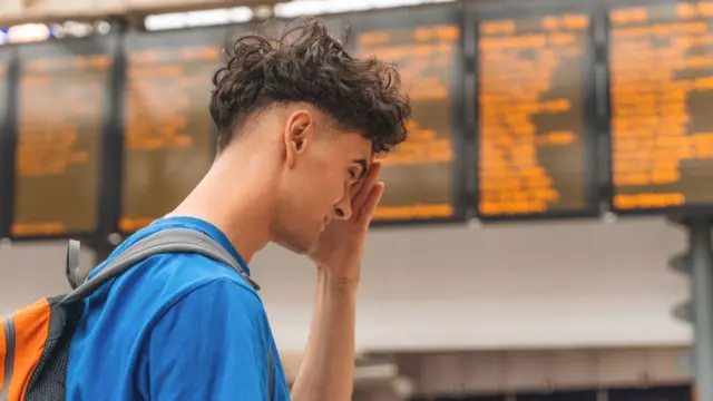 Young man checking train schedules