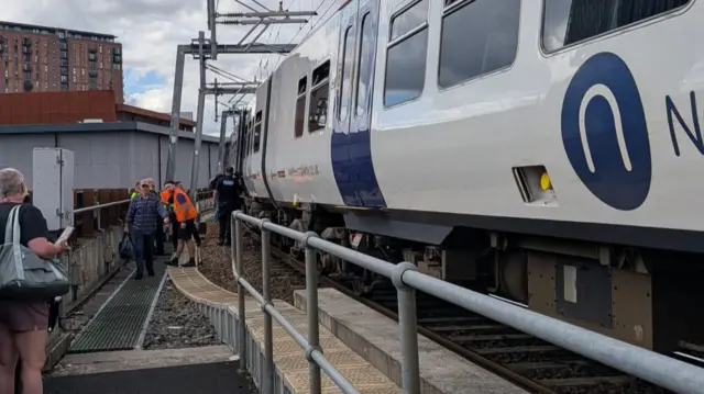 Passengers being evacuated from a train after it was forced to stop amid rail disruption