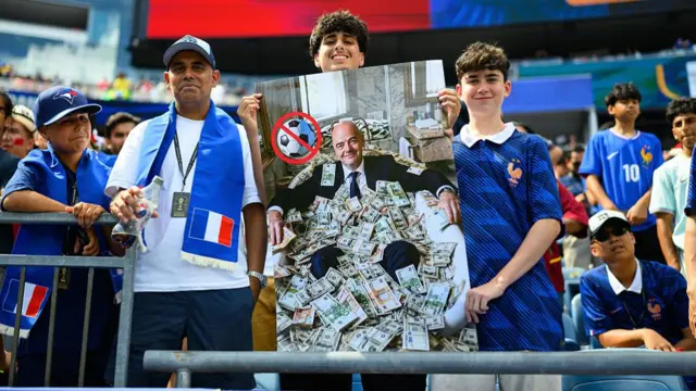 French fans present a picture of FIFA President Gianni Infantino with bank notes during the FIFA World Cup 2026 Quarter Final match between France and Morocco