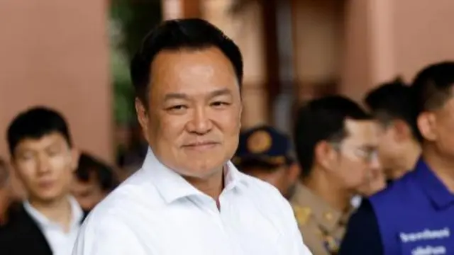 Anutin Charnvirakul is pictured with a slight smile, wearing a white shirt.