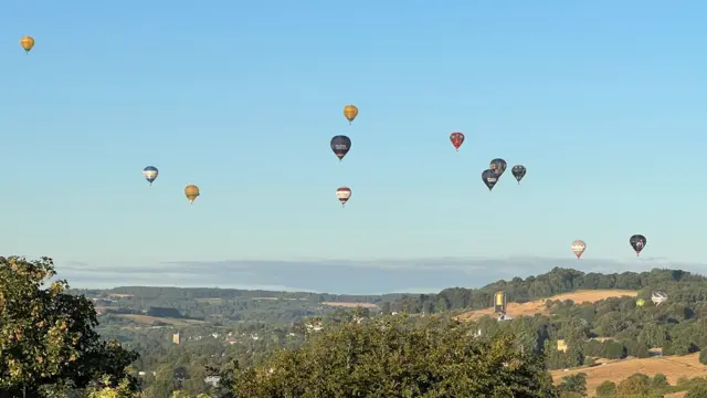 Twelve balloons up in the sky above Ashton Court and the outskirts of the city.